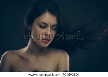 Art studio portrait of young gorgeous brunette girl