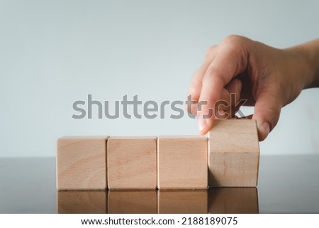 Hand Flipping wooden block in row on table over white backgroudn use for creator,put logo,text,icon concept. Stock foto © 