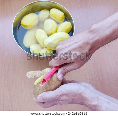 Similar – Image, Stock Photo Unrecognizable chef peeling potato in kitchen