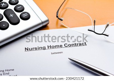 Contract about a nursing service on an outpatient basis with calculator, pair of glasses and ballpoint pen