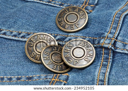 Jeans metal buttons on denim. Macro shoot.