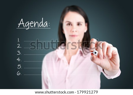 Young business woman writing blank agenda list.