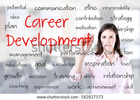Young business woman writing career development concept. Office background.