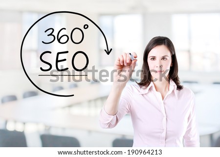 Businesswoman drawing a 360 degrees SEO concept on the virtual screen. Office background.