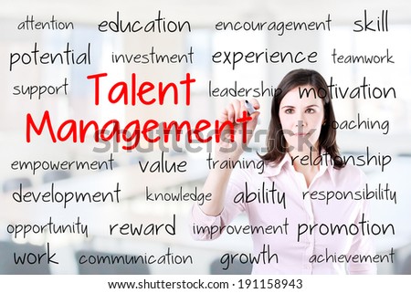 Business woman writing talent management concept. Office background.