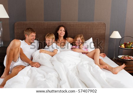 happy family in bed - good morning