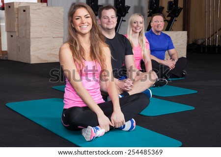 Sports group people preparing for sport exercise sitting on yoga mate