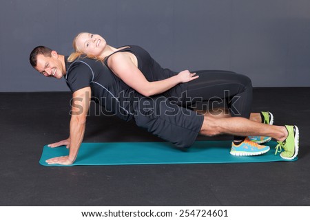 Body weight push up - woman laying on man doing push ups