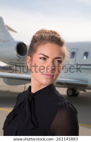 business woman in front of a corporate jet