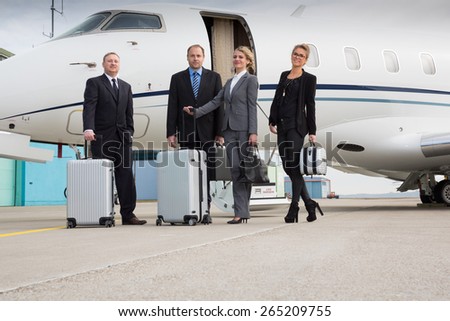 executive manager leaving corporate jet handshake with pilot