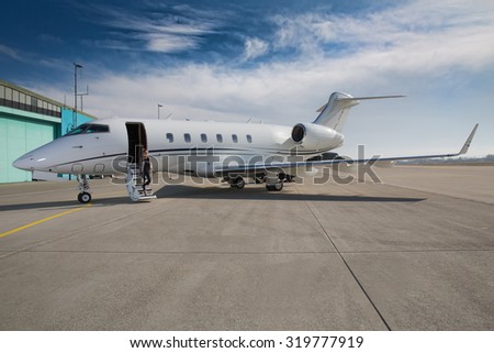executive business woman leaving a corporate jet plane