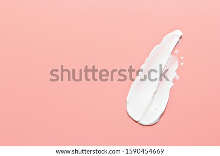 White beauty cream lotion highlighter smear swatch smudge on pink peach background Сток-фото © 