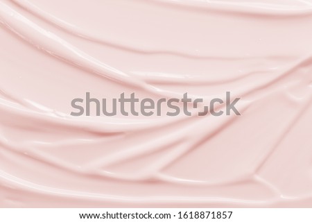 Beauty cream texture background. Pink color face cream lotion moisturizer smear. Skincare cosmetic  product  strokes