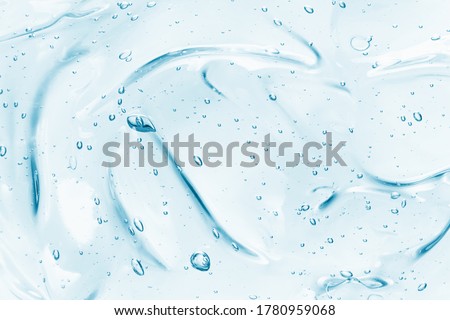 Hand sanitizer gel background. Clear colored cream with bubbles texture. Skincare hygiene product closeup