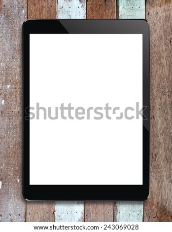 Digital tablet with blank screen area for copy space on vintage wooden background.