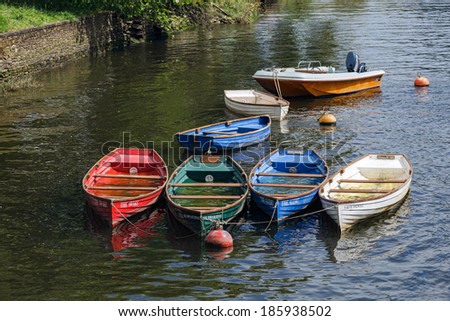 TOTNES, DEVOV/UK - JULY 29 : Group of rowing boats full with rainwater on the River Dart at Totnes on July 29, 2012