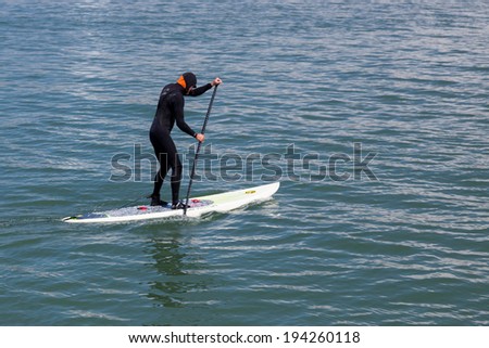 SAUSALITO, CALIFORNIA/USA - AUGUST 6 : Paddling surf board out of Sausalito marina in California on August 6, 2011. Unidentified man.