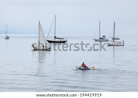 SANTA BARBARA, CALIFORNIA/USA - AUGUST 10 : Man rowing dinghy off Santa Barbara beach on August 10, 2011. Unidentified person.