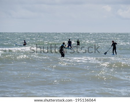 BRIGHTON, EAST SUSSEX/UK - MAY 24 : People paddle boarding at Brighton East Sussex on May 24, 2014. Unidentified people.