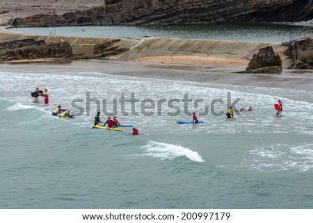 BUDE, CORNWALL/UK - AUGUST 15 : People learning to surf at Bude in Cornwall on August 15, 2013. Unidentified people.