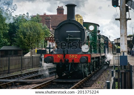 SHEFFIELD PARK, EAST SUSSEX/UK - SEPTEMBER 8 : C Class steam engine leaving Sheffield Park station East Sussex on September 8, 2013. Unidentified people.