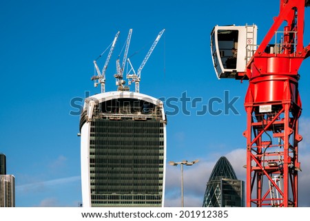 LONDON - DECEMBER 6 : Red crane operating in London on December 6, 2013. Unidentified man.