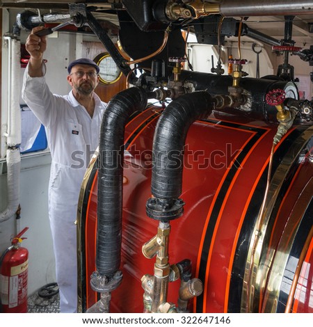 CONISTON WATER, LAKE DISTRICT/ENGLAND - AUGUST 21 : Boiler Room of the Steam Yacht Gondola on Coniston Water in the Lake District England on August 21, 2015. Unidentified man.