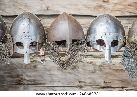 Replica of a medieval warrior Viking helmets on wooden background.