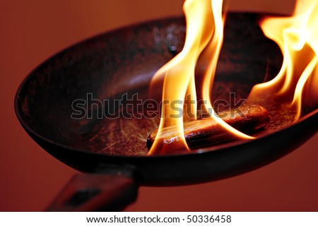sausage in the flame in frying pan