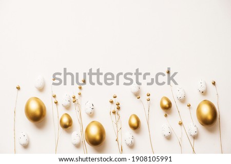 Stylish golden eggs easter concept. Easter gold eggs with golden dried flax linum bunch white background. Flat lay trendy easter. Happy easter card. Copy space for text