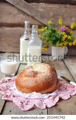 Bun with butter and milk. Breakfast in rustic style. Selective focus