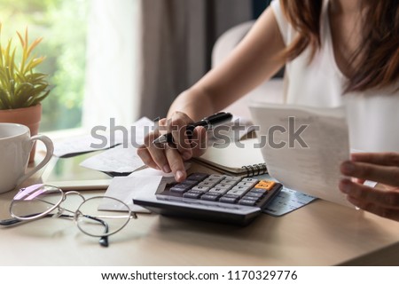 Stressed young woman calculating monthly home expenses, tax, bank account balance and credit card bills payment, Income is not enough for expenses. Stockfoto © 