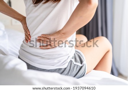 Woman suffering from back ache on the bed, healthcare and problem concept Photo stock © 