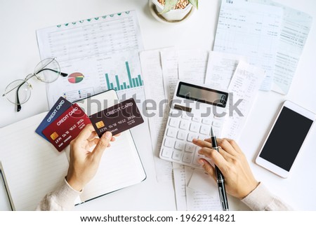 Stressed young woman calculating monthly home expenses, taxes, bank account balance and credit card bills payment, Income is not enough for expenses
