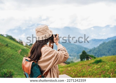 Similar – Image, Stock Photo Travelers taking photo on seaside at sunset