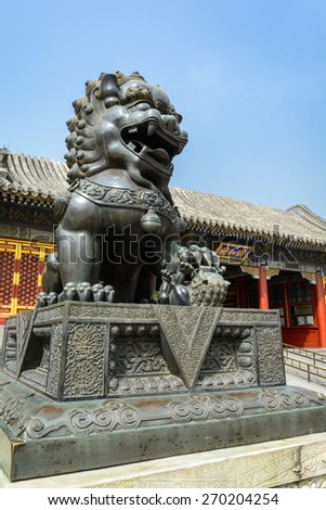 Copper lion in front of an ancient architecture in summer palace, Beijing China
