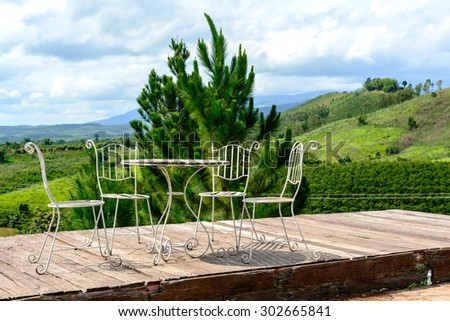 tables and chairs on terrace and nice view over the mountain
