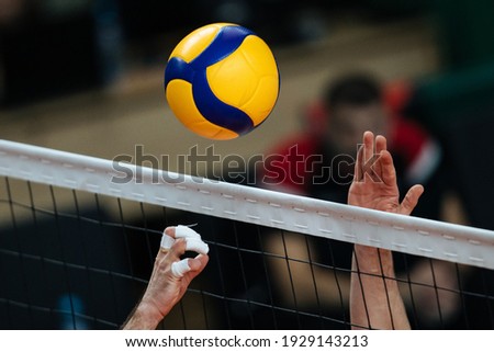 Volleyball action. Ball  above net during volleyball game. 
