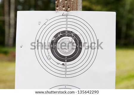 Shooting practice target with bullet holes