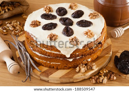 honey cake with plum and walnut on kitchen table