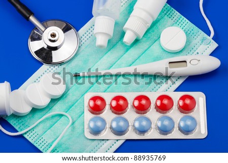 Set for flu treatment: pills, thermometer, nasal sprays, protective surgical mask, stethoscope