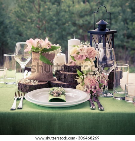 Wedding table setting decorated in rustic style. Retro styled photo