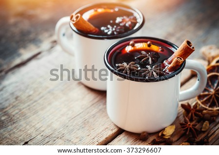 Mulled wine in white rustic mugs with spices and citrus fruit Сток-фото © 