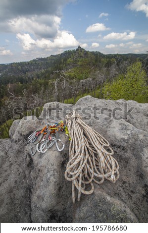 Climbing rope and snap-hook on the sandstone rock in National Park Bohemian Switzerland