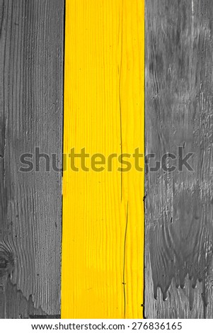 Three wooden boards, painted with yellow paint in the middle