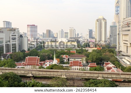 BANGKOK,THAILAND-FEBRUARY 17:Bangkok Mass Transit System (BTS) pass the Pathumwanaram temple at siam in sunny day on February 17,2015