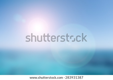 abstract blurred nature background of blue sea and sky with sun light and red flare
