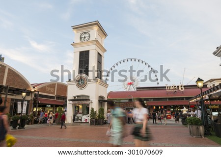 BANGKOK, THAILAND - MAY 30 : The clock tower with ferris wheel and warehouse background at the asiatique river front on May 30, 2015 Bangkok, Thailand