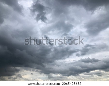 Atmosphere of overcast sky before to rainy.Dusk overcast sky in rainy season. Dark cloudy against white sky. Rain cloudy floating on sky frame. Copy space for text or word to do background work.