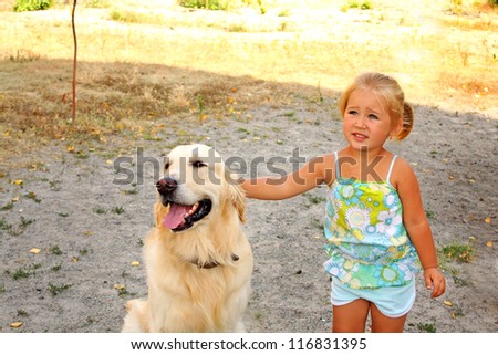 Portrait of the little girl with  the big dog